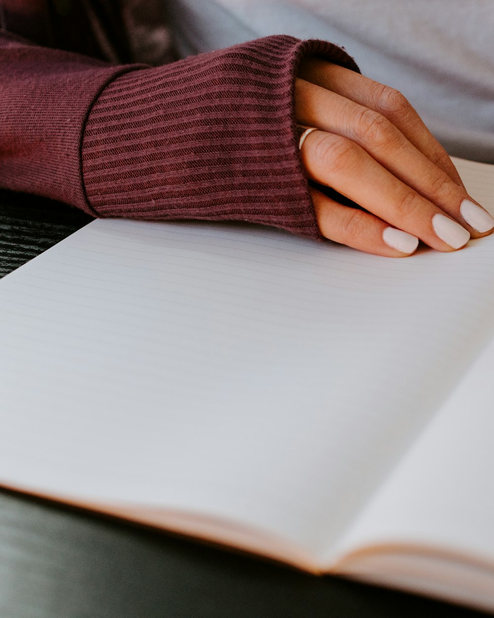 Hands writing gently in an open journal